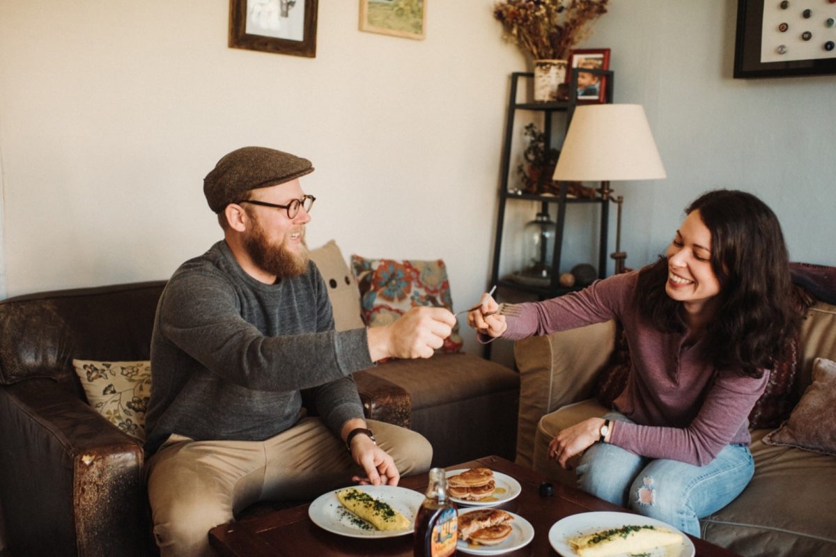 couple cooking for engagement photos