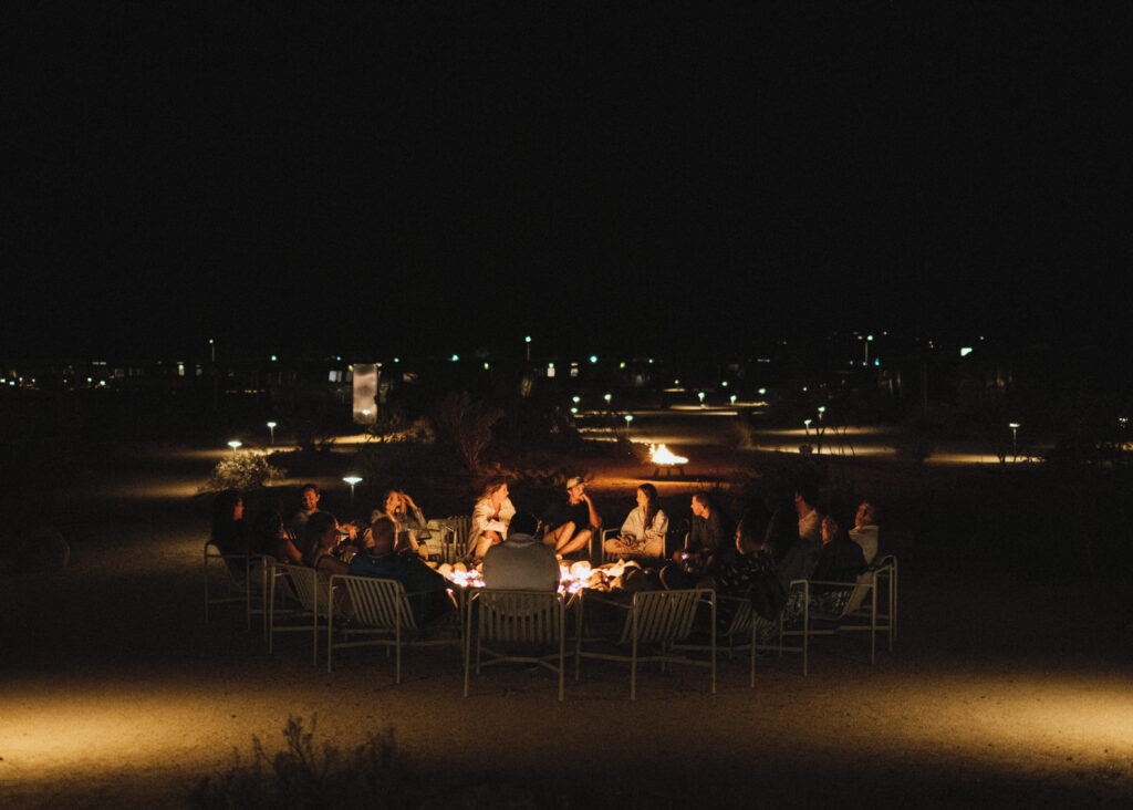 People gathered around the fire pit at AutoCamp