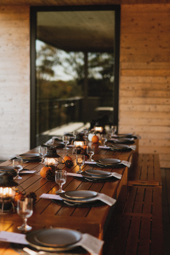 Dining Table set on outdoor deck of The Bridgeroom at AutoCamp Cape Cod