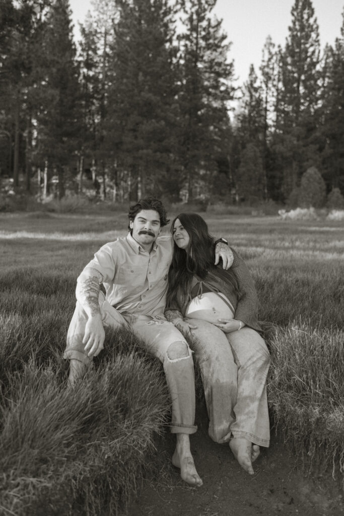 Couple sitting in a meadow in Lake Tahoe.