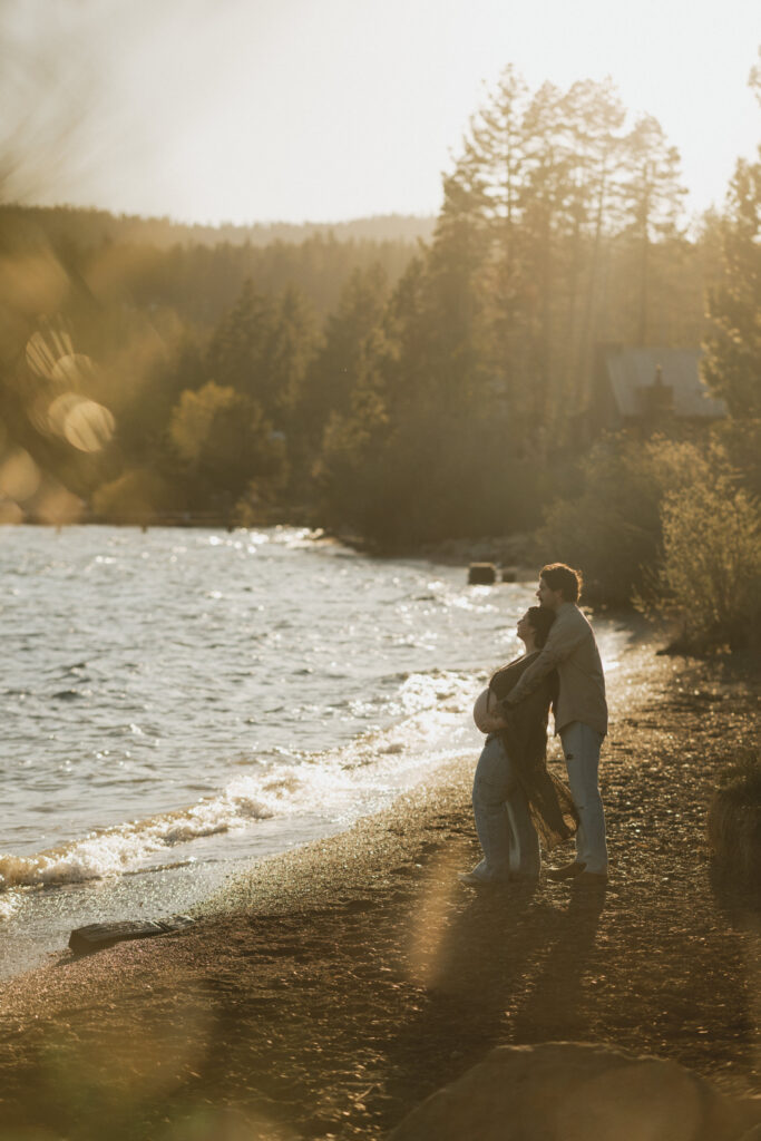 Golden Sunset with Couple embracing on the shores of Lake Tahoe.